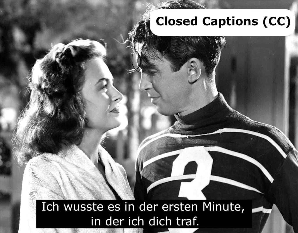 Eine klassische Filmszene mit Untertiteln im Closed-Captions (CC)-Format. Der weiße Text ist in zwei Zeilen auf schwarzen Balken dargestellt und nutzt eine gut lesbare Standardschrift, wie sie häufig für Untertitel in TV- und Videoproduktionen verwendet wird.